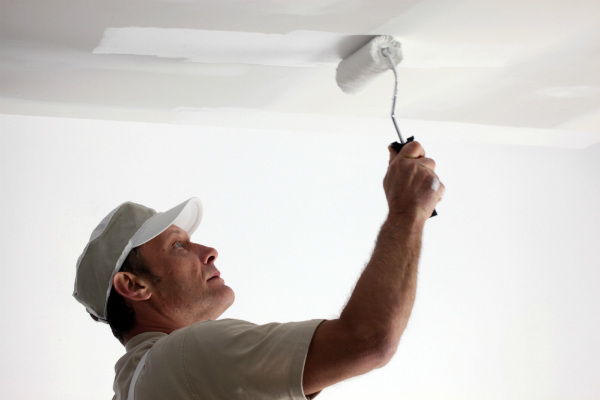 rolling paint onto a ceiling