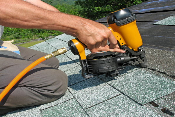 roofing a home with a nail gun