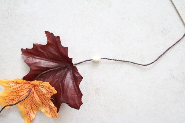Threading bead onto cord.
