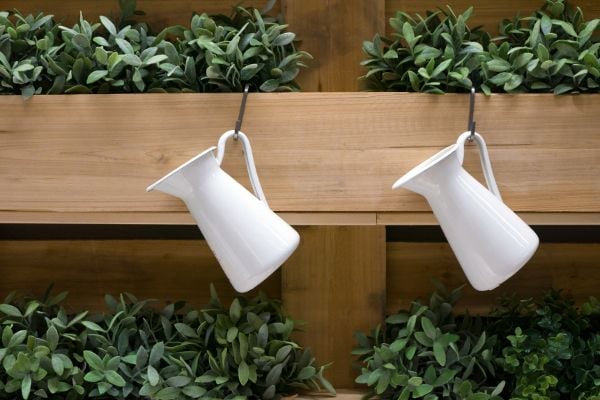 Plant boxes with hooks and white pitchers. 