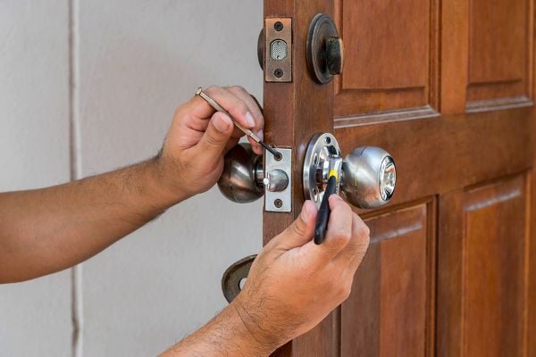 person working on a door lock
