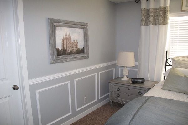 A bedroom with wainscoting. 