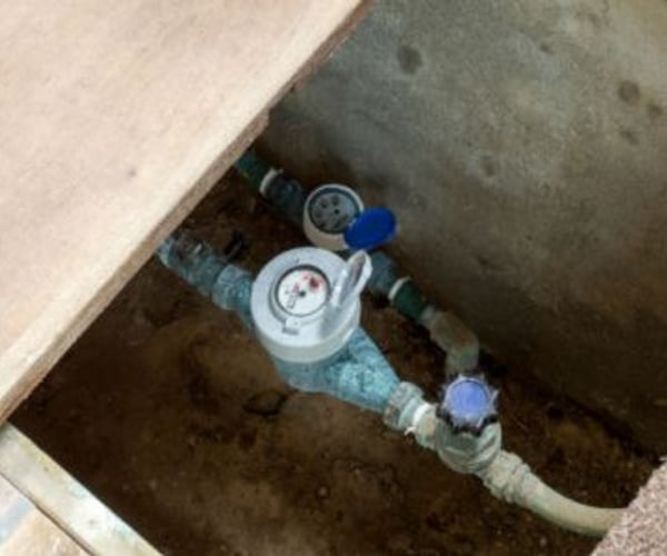 open crawl space with water pipes