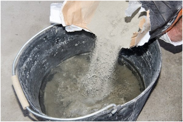 pouring concrete powder from bag