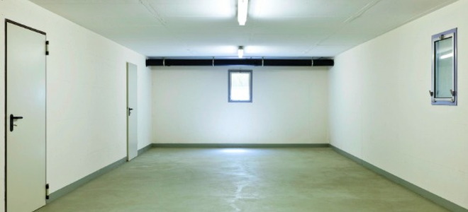 empty room with concrete floor and white walls