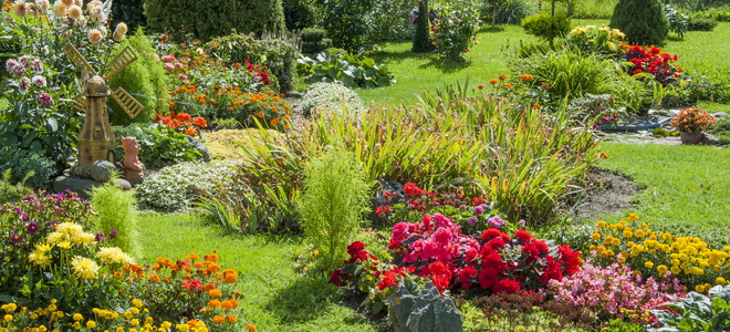 Colorful flower plantings throughout a large grassy yard