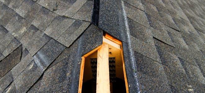 The hole for a ridge vent on a roof under construction.