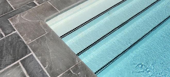 A saltwater pool with steps and a stone deck.