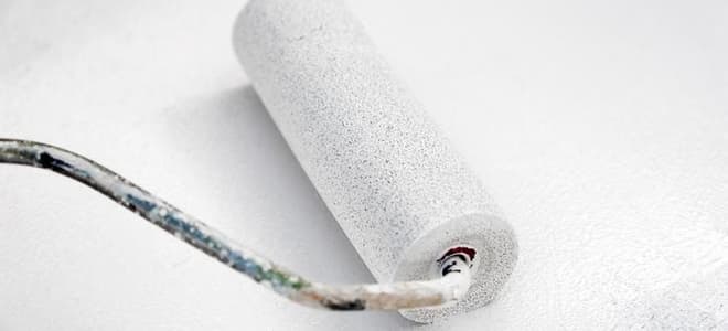 paint roller with covered in white paint