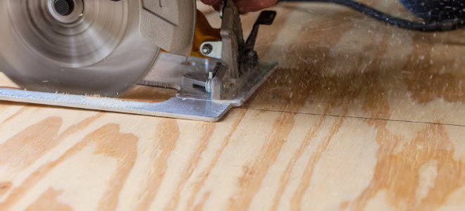 circular saw cutting through plywood