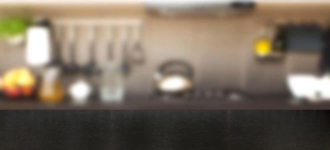 Dark laminate kitchen countertop in the foreground.