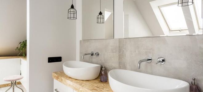 A pair of vessel sinks in a bathroom. 