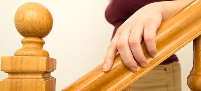 a woman holding a wooden star railing