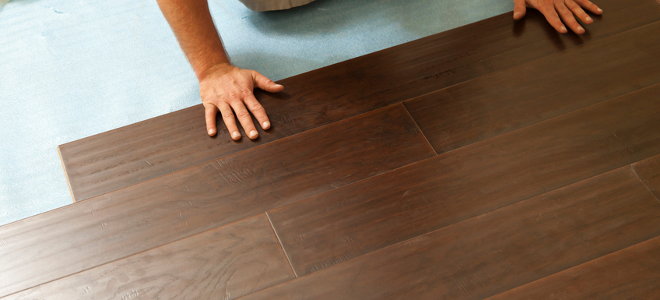 A man installs laminate floors.