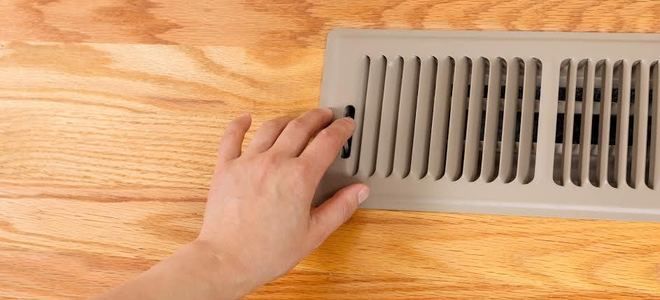 A vent register in wood flooring.