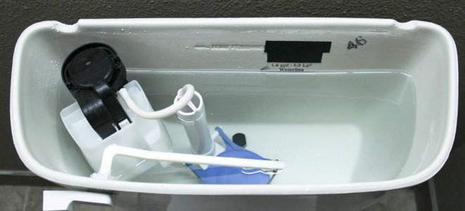 Looking down at an open toilet tank.