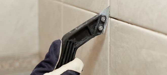 cutting grout between tiles with a utility knife