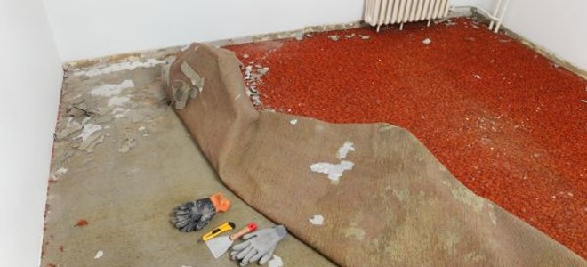 A room of carpet being removed.