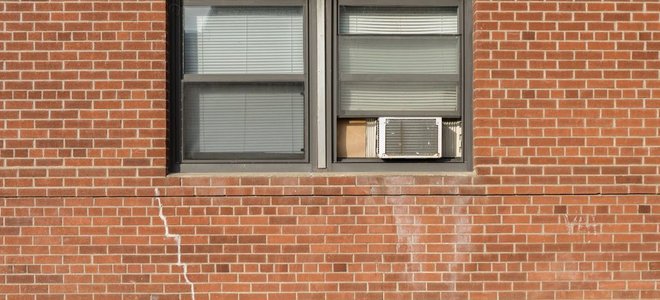 Window air conditioning unit in a brick complex.