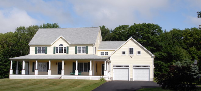large house with lawn and asphalt driveway