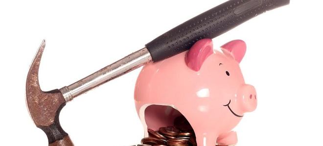 Hammer on top of broken piggy bank
