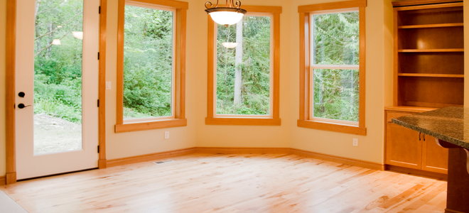 empty room with large windows and wood floor