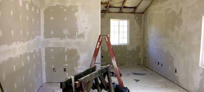 Ladder in a room with drywall.