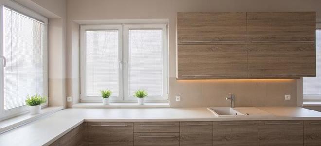 bright windows surrounded by brown cabinets