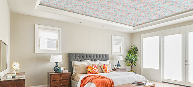 A bedroom with a wallpaper statement ceiling