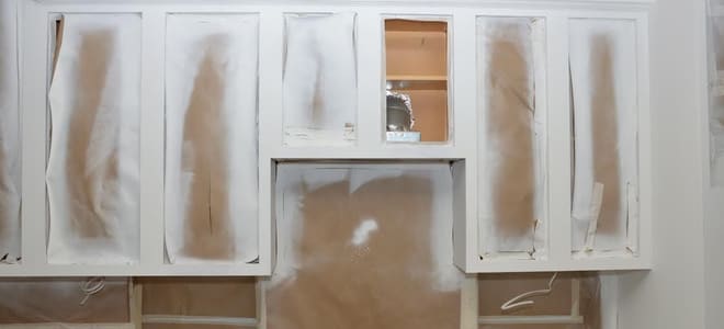 Painting cabinets in a kitchen white. 