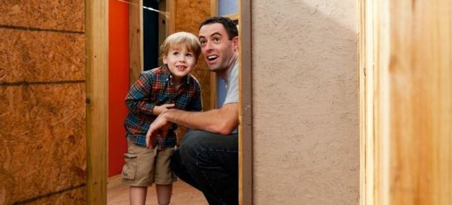 A father and son in a new, backyard playhouse