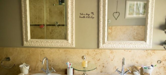 bathroom with two sinks and mirrors above