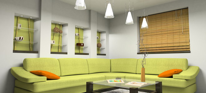 Living room with drop lighting, green couch, and Roman blind