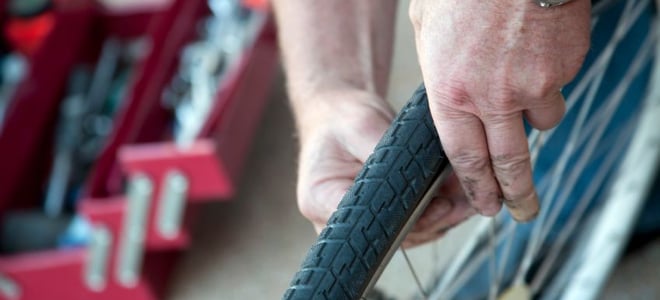 A man inspected a bike tire