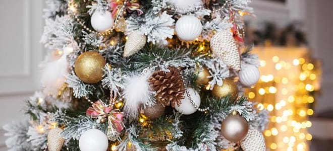 A close-up image of a flocked and decorated Christmas tree. 