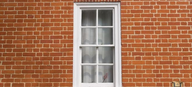 brick building with a white sash window
