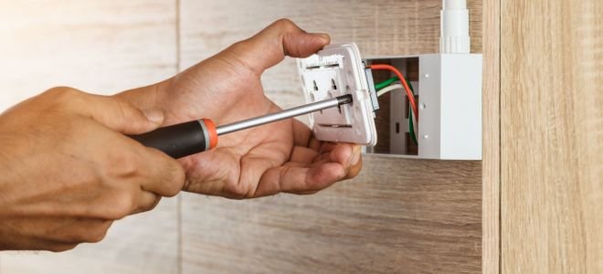 hands installing outlet