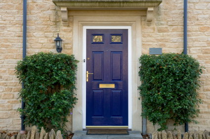 blue front door with gold mail slot