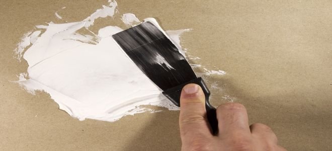 spreading compound on a drywall hole