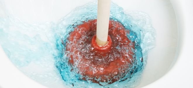 plunger in a toilet bowl