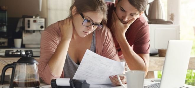 concerned couple looking at bills