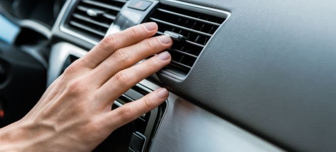 hand in front of car HVAC vent