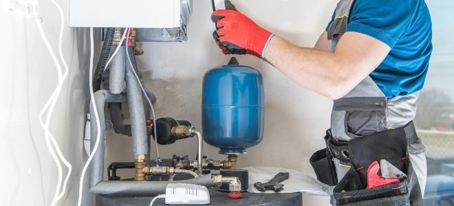 man maintaining an oil furnace