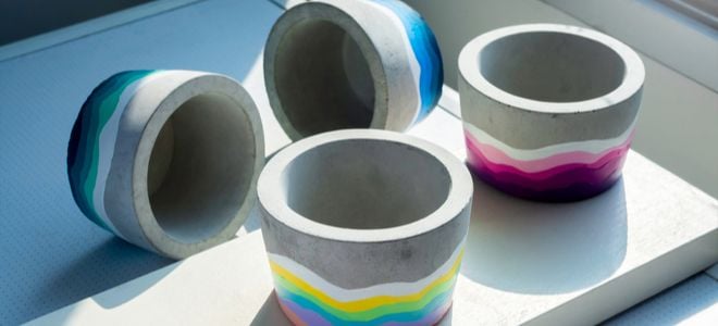 small concrete planters with curved paint designs