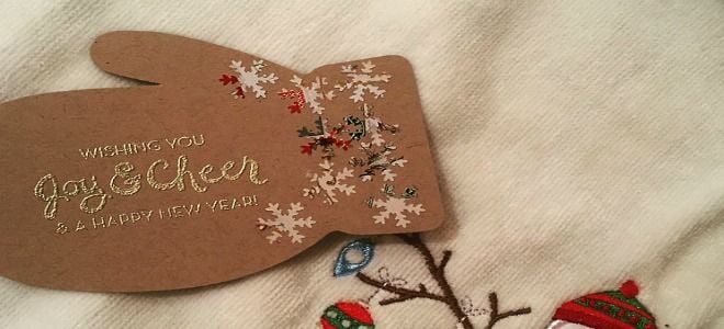 A gift tag in the shape of a mitten. 