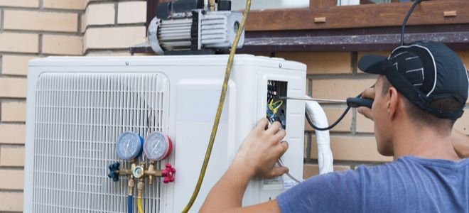 man evacuating outdoor AC unit