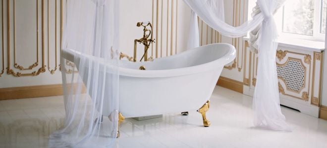 freestanding bathtub with white curtains