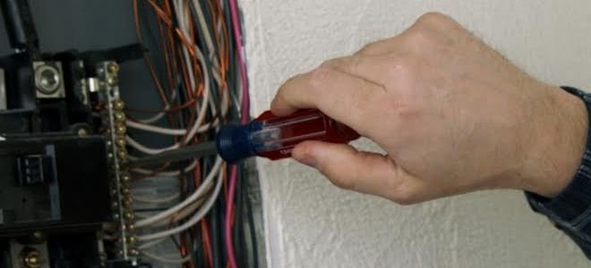 Man working on electrical panel
