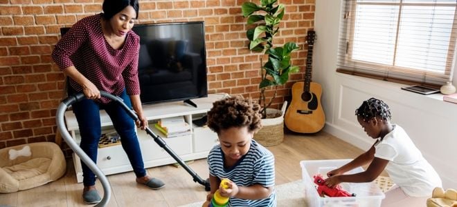 family cleaning a living room