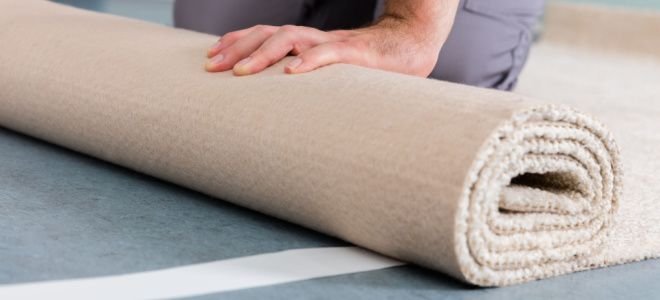 hands unrolling carpet